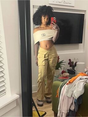 Cream Off-Shoulder Ribbed Crop Top with Center Emblem